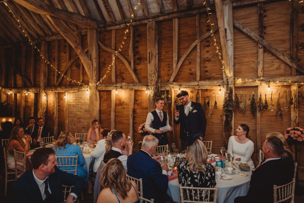 Rustic wedding reception with people and speeches.