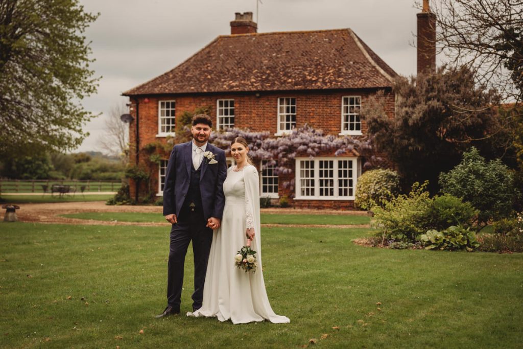 Wedding couple outside brick country house