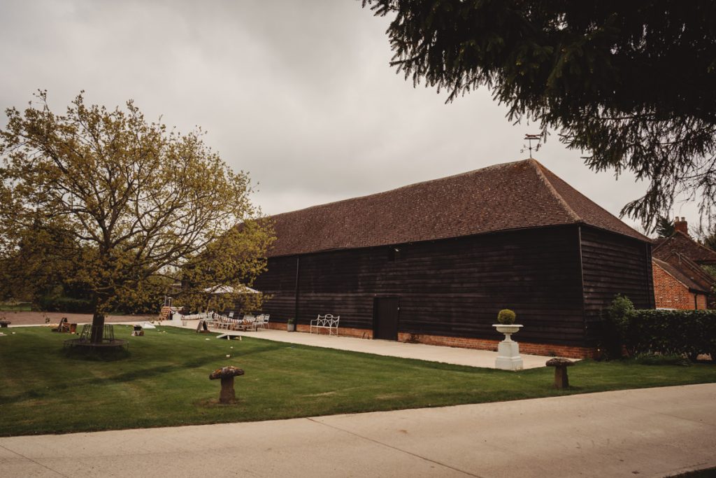 Large rustic barn with surrounding garden