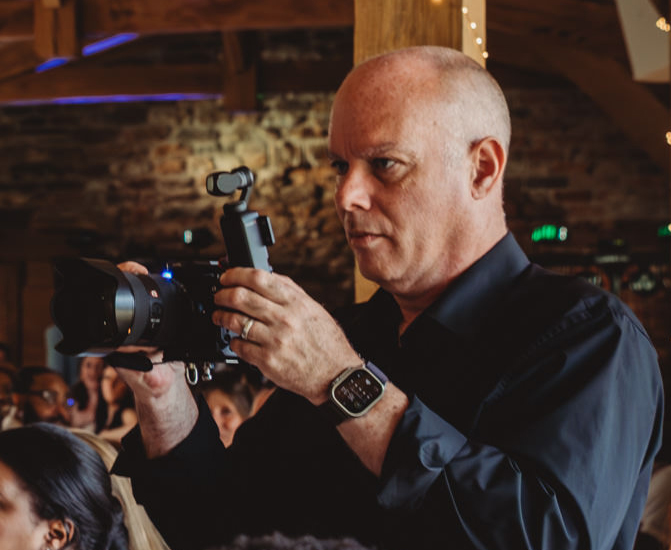 Photographer taking pictures at indoor event.