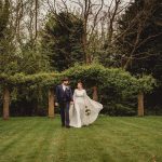 Bride and groom walking in a garden