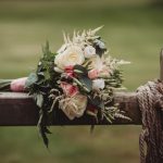 Rustic rose bouquet on wooden fence outdoors