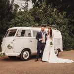 Bride and groom with vintage wedding van.