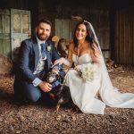 Wedding couple with dog in rustic setting