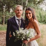 Wedding couple smiling in forest setting