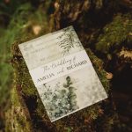 Wedding invitation on mossy tree stump