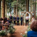 Outdoor wedding ceremony in a forest setting.