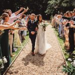 Bride and groom celebrate with guests at wedding.