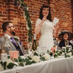 Bride giving speech at wedding table