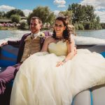 Wedding couple enjoying boat ride on sunny day.