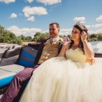 Bride and groom smiling on a boat ride.