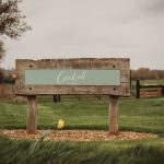 Crockwell Farm sign on grassy field.