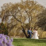 Bride and groom walking in scenic garden