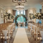 Elegant wedding ceremony room with floral arch.