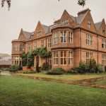 Victorian mansion with lush garden