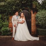 Bride and groom by garden door