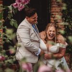 Joyful couple laughing at their wedding