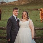 Bride and groom with Highland cows background