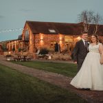 Bride and groom outside rustic wedding venue