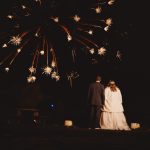 Couple watching fireworks display at night