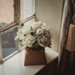 Elegant bouquet of white flowers on windowsill