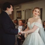 Bride and groom exchanging vows at wedding ceremony.