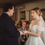 Bride and groom exchanging vows at wedding ceremony.