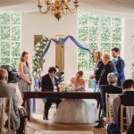 Wedding ceremony with couple signing marriage register.