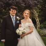 Bride and groom in garden, smiling.