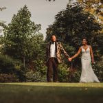 Couple walking hand in hand in garden