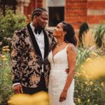 Bride and groom smiling in garden setting