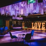 Luxurious party room with glowing Love sign.