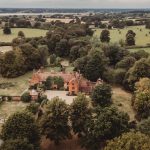 Aerial view of English countryside estate and fields.