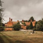 Historic estate with gardens and outdoor seating area.