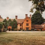 Historic mansion with ivy-covered brick facade.