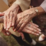 Three generations' hands together, showing rings.