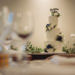 Elegant wedding cake with floral decorations.