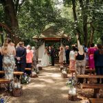 Outdoor wedding ceremony in forest setting.