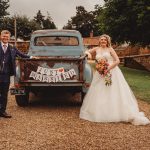 Wedding couple with 'Just Married' car banner.