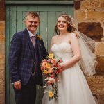 Bride and groom smiling with flowers