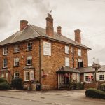 Historic country pub with a swan sign.