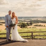 Bride and groom in countryside landscape