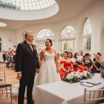 Bride and groom smiling during wedding ceremony.