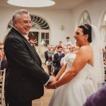 Happy couple exchanging vows at wedding ceremony.