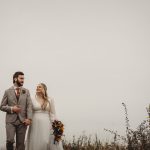 Bride and groom walking outdoors on wedding day.