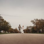 Bride and groom walking on country road