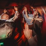 People dancing energetically at a lively party.