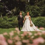 Bride and groom in garden wedding ceremony.