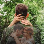 Couple embracing in forest, wedding photo overlay.