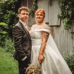 Bride and groom in garden setting.